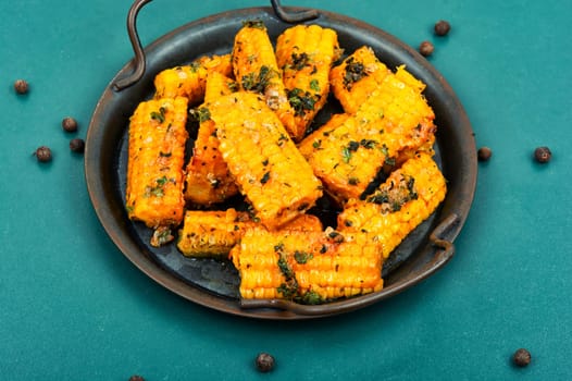 Delicious grilled corn with spices and herbs. Vegetarian food, recipes.