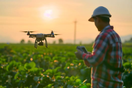 Farmer in the field using drone. Neural network generated in January 2024. Not based on any actual scene or pattern.