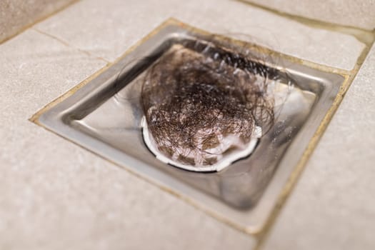 Clogged with dirty and hair over sewer pipes floor drain at bathroom