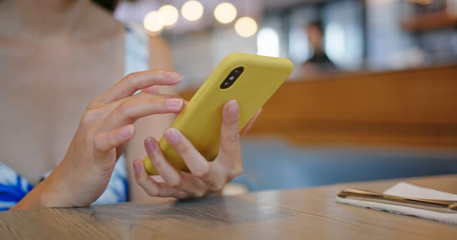 Woman use of mobile phone at outdoor cafe