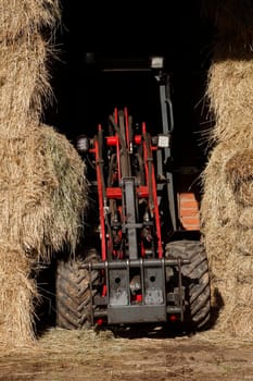 Straw bales with a tractor, Lower Saxony, Germany
