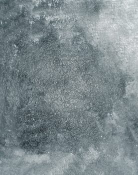 The texture of an old glossy rough wall with spots and irregularities on the surface in close-up
