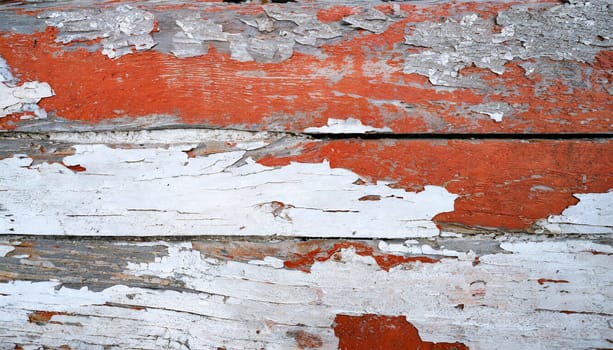 Light blue red and green weathered wooden background with cracked paint.