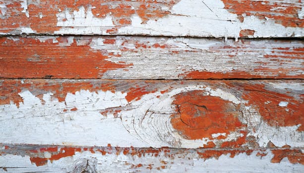 Light blue red and green weathered wooden background with cracked paint.