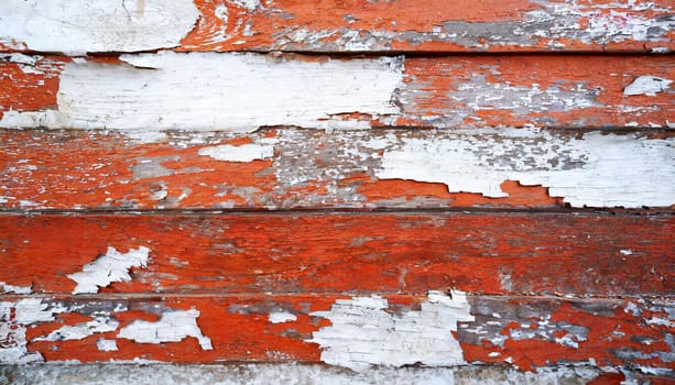 Light blue red and green weathered wooden background with cracked paint.