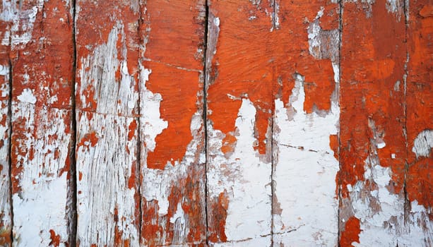 Light blue red and green weathered wooden background with cracked paint.