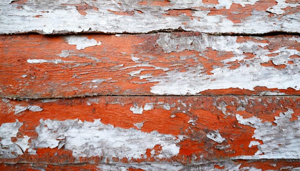 Light blue red and green weathered wooden background with cracked paint.