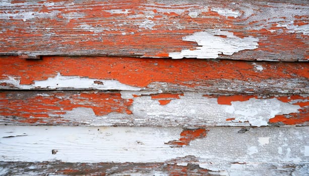 Light blue red and green weathered wooden background with cracked paint.