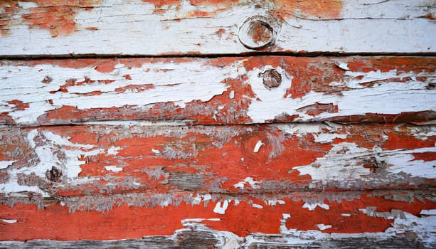 Light blue red and green weathered wooden background with cracked paint.