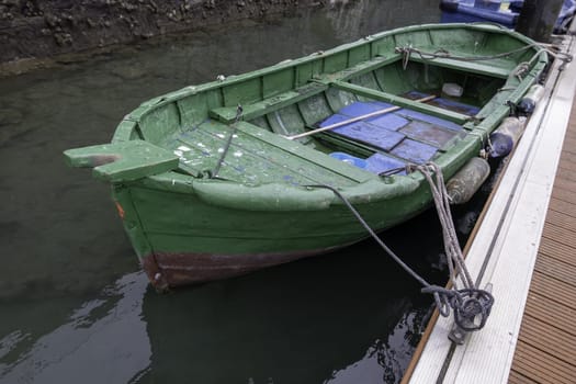 Detail of old abandoned boat on a dock in the sea