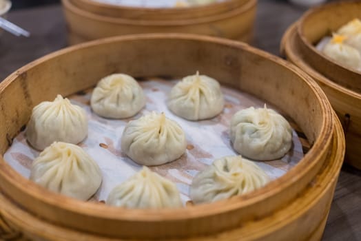 Steamed xiaolongbao served in a traditional steaming basket