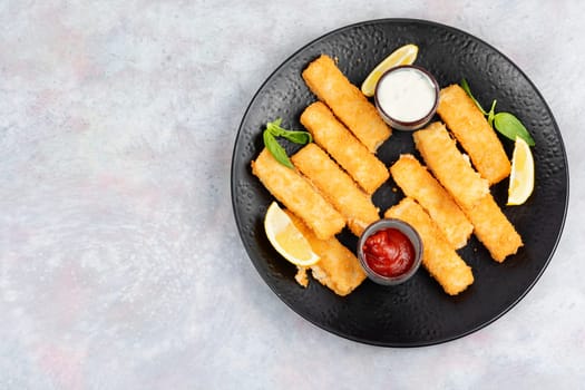 Delicious fish fingers or nuggets, crispy fish steak on the plate.
