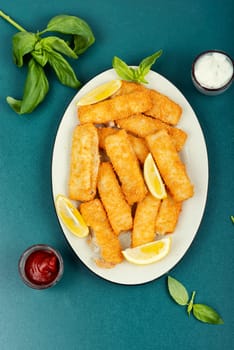 Delicious fish fingers or nuggets, crispy fish steak on the plate.