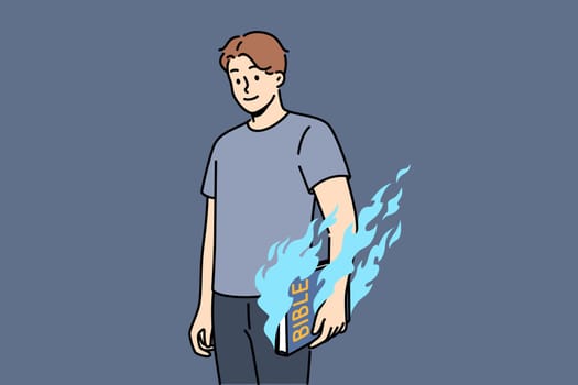 Man holds bible and feels magical energy emanating from religious book with old testament or prayers. Burning bible in hands of guy who wants to destroy symbol of catholicism or christianity