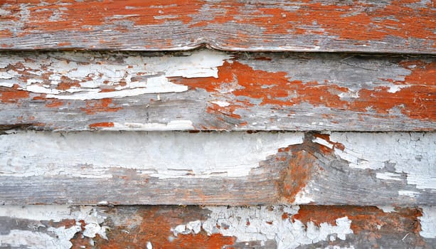 Light blue red and green weathered wooden background with cracked paint.