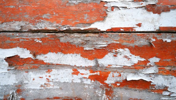 Light blue red and green weathered wooden background with cracked paint.