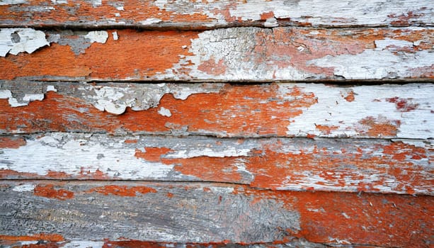 Light blue red and green weathered wooden background with cracked paint.