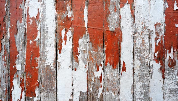 Light blue red and green weathered wooden background with cracked paint.
