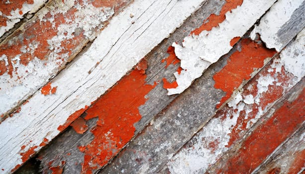 Light blue red and green weathered wooden background with cracked paint.