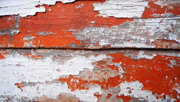 Light blue red and green weathered wooden background with cracked paint.