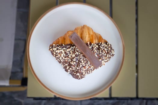 Delicious dessert chocolate croissant for breakfast, stock photo