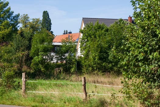 Residential buildings with pasture and fence, Wunstorf, Lower Saxony, Germany