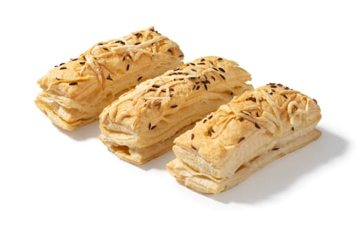 Three golden-brown crackers, each topped with a sprinkle of savory cheese