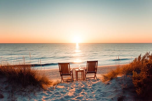Two chairs face the sunset on a secluded beach, offering a peaceful retreat. Copy space