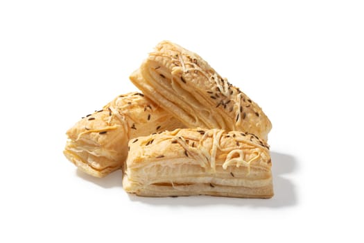 Three delectable cheese crackers, each adorned with a savory blend of cheddar. A delightful trio perfect for elevating your snacking experience