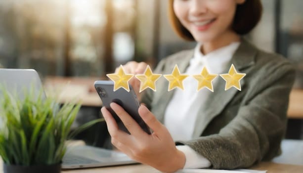 Close up of woman customer giving a five star rating on smartphone. Review, Service rating, satisfaction, Customer service experience and satisfaction survey concept