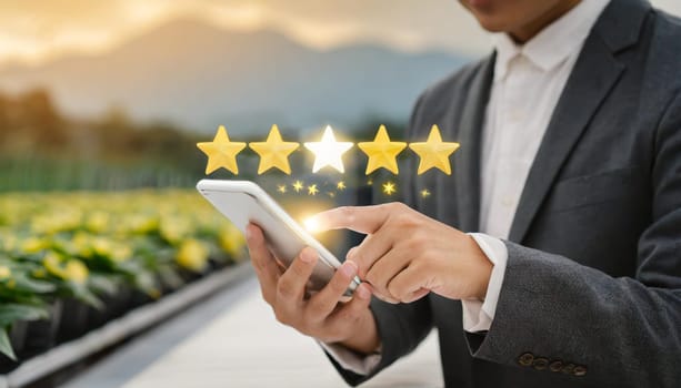 close up on customer man hand pressing on smartphone screen with gold five star rating feedback icon and press level three rank (good) for give score point to review the service business concept