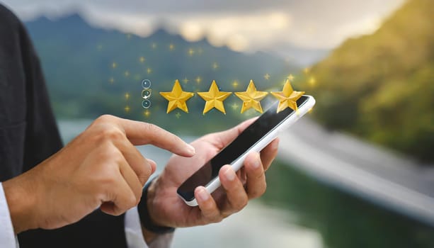 close up on customer man hand pressing on smartphone screen with gold five star rating feedback icon and press level three rank (good) for give score point to review the service business concept