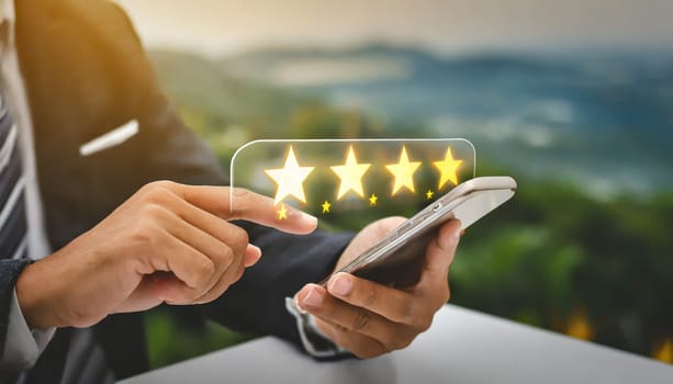 close up on customer man hand pressing on smartphone screen with gold five star rating feedback icon and press level three rank (good) for give score point to review the service business concept