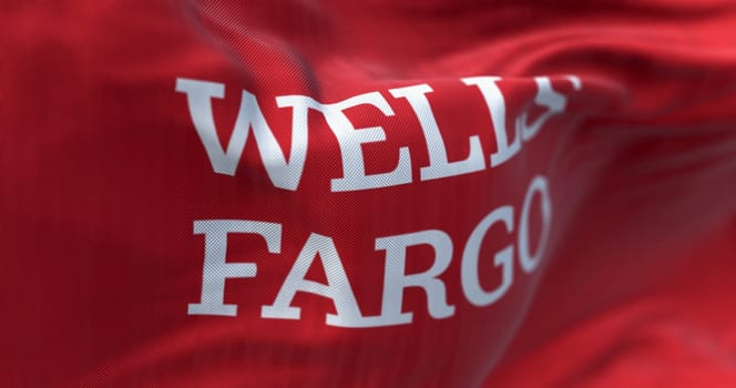 San Francisco, US, Mar. 5 2024: Close-up of Wells Fargo bank flag waving. Finance and banking Illustrative editorial 3d illustration. Selective focus