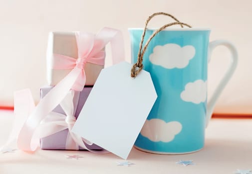 Birthday card with empty copy space tag. Father's, mother's day greetings. Gift boxes and mug holiday design.