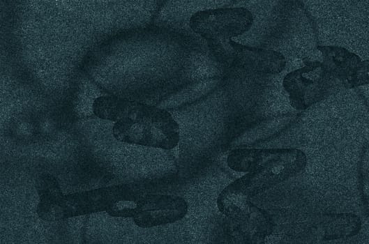 The background texture of a dark gray rough wall with an abstract pattern and spots