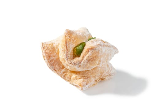 A delightful treat featuring flaky puff pastry filled with green Turkish Delight and dusted with a veil of powdered sugar
