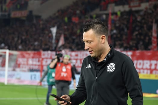 After the interview,referee: Sven Jablonski (Bremen) checks his mobile phone before the match of the 1st FBL: 23-24: 24. SC Freiburg - FC Bayern Munich  DFL REGULATIONS PROHIBIT ANY USE OF PHOTOGRAPHS AS IMAGE SEQUENCES AND/OR QUASI-VIDEONann  Photo: Joachim Hahne/johapress