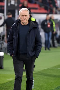 Coach Christian Streich (SC Freiburg) on his way to a TV interview ahead of the Europa League match - Round of 16: SC Freiburg vs West Ham United