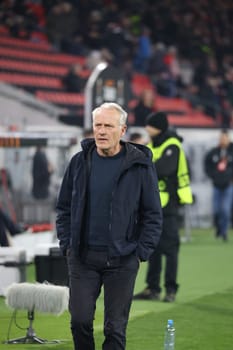 Coach Christian Streich (SC Freiburg) on his way to a TV interview ahead of the Europa League match - Round of 16: SC Freiburg vs West Ham United