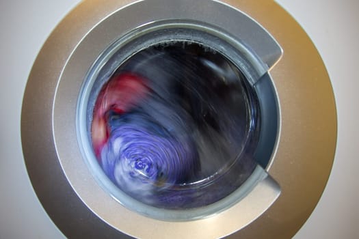 a close view of domestic washing machine at work.