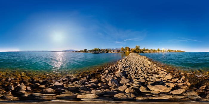 seamless 360 degree spherical panorama of breakwater cape on Issyk-Kul lake at sunny autumn day.