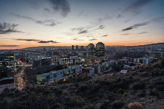Panoramic view at dusk of La Marina de Port, a quarter of the Sants-Montjuic district, located in the south-west of Barcelona and bordering Hospitalet de Llobregat, a city that is the second largest municipality in Catalonia in terms of number of inhabitants.
