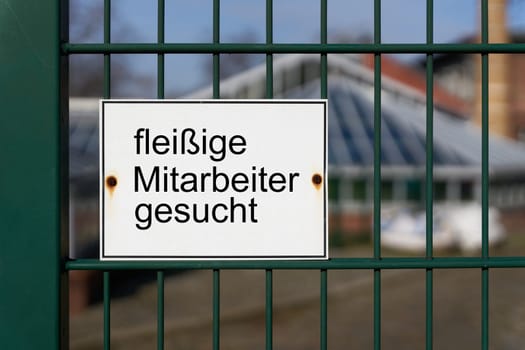 Sign with the German inscription fleissige Mitarbeiter gesucht, as an indication of the shortage of trained specialists in Germany. Translation: hard-working employees wanted
