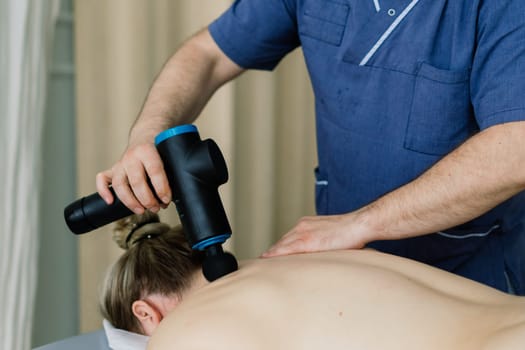 Plump woman getting hot stones arm massage in a spa salon. Therapy, wellness and relaxation concept