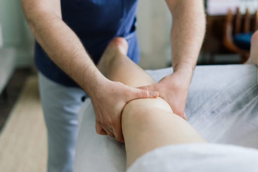 Young fat woman getting massage treatment in a day spa cabinet.