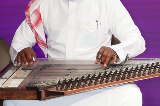 A musician playing qanun