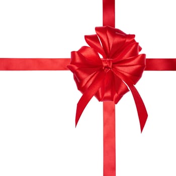 Red silk ribbon and a tied big bow on an isolated background, top view. Gift packaging