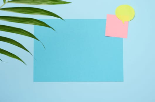 Blank rectangular sheet of paper on a blue background, copy space