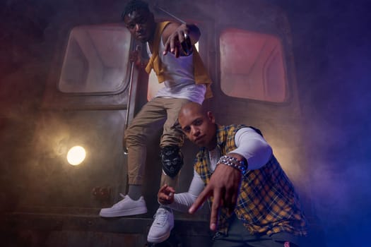 Young rappers performing shooting video in misty subway underground. Concept of music and hip-hop generation